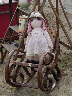 Doll in rocking chair at French brocante