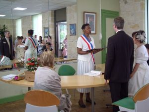 Maire wearing tri-coloured scarf celebrating marriage in France-bride-groom-witness