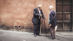 2 old men talking-wall-wooden door