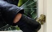 Burglar breaking window