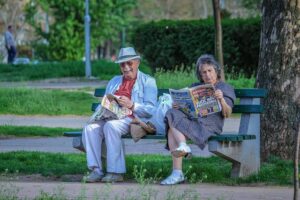 Elderly people sat on a park bench